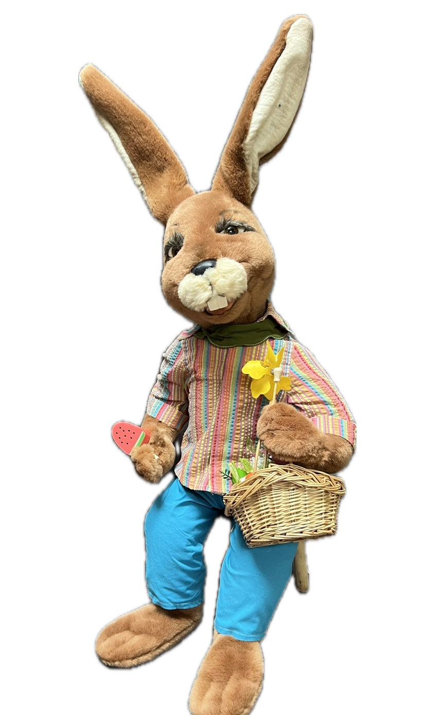 Sitting rabbit with basket and piece of melon 